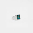 Silver ring with an abalone shell stone on a white background
