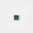 Silver ring with an abalone shell stone on a white background