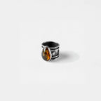 Silver ring with a amber stone on a white background
