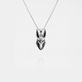 Silver Anubis pendant necklace on a light gray background