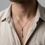 MAN WEARING AN ARROW SILVER PENDANT ON A WHITE BACKGROUND