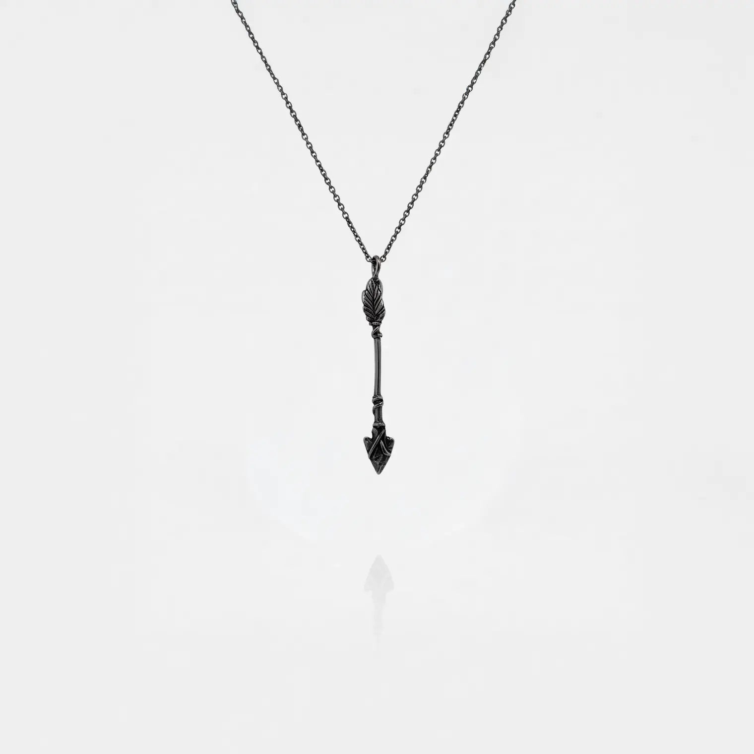 ARROW SILVER PENDANT ON A WHITE BACKGROUND