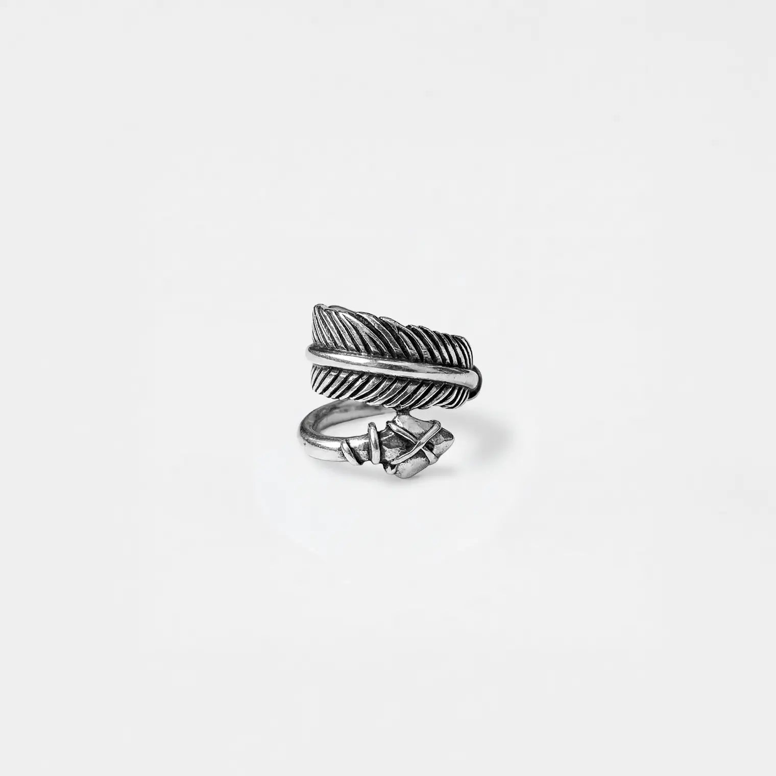 Silver A-shaped ring on a light gray backgroundROW