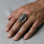 man's hand wearing an Ascension of Quetzalcoatl silver Ring on a gray background