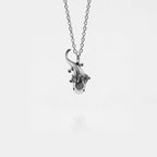Silver AXOLOTL-shaped pendant on a chain against a white background