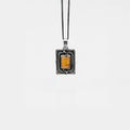 Necklace with a rectangular pendant featuring amber on a white background