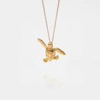 baby turtle gold pendant on a white background