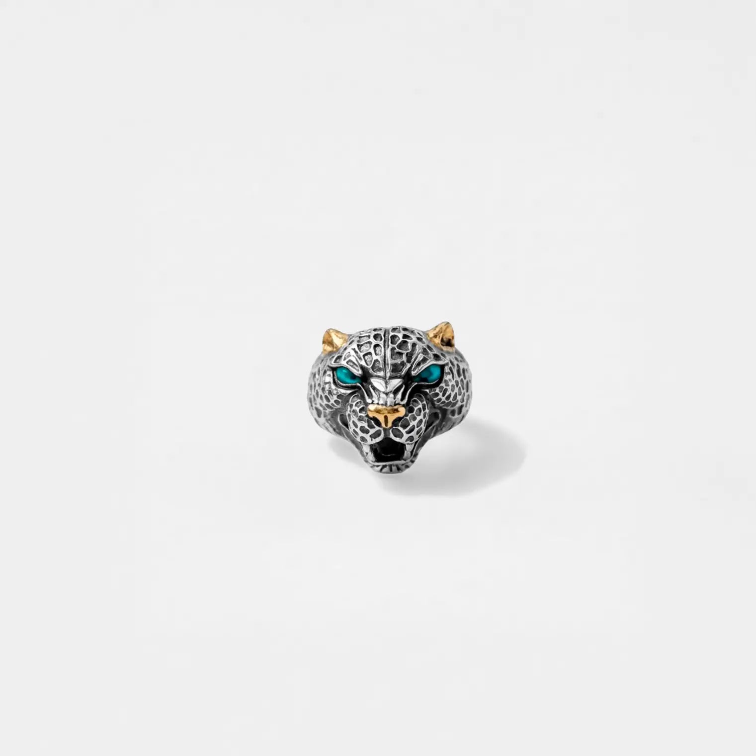 Silver jaguar  head ring with blue eyes on a white background