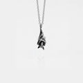 Silver bat pendant necklace on a white background