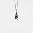 Silver bat pendant necklace on a white background