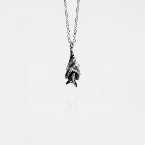 Silver bat pendant necklace on a white background