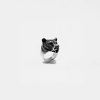 Silver ring with a bear head design on a white background