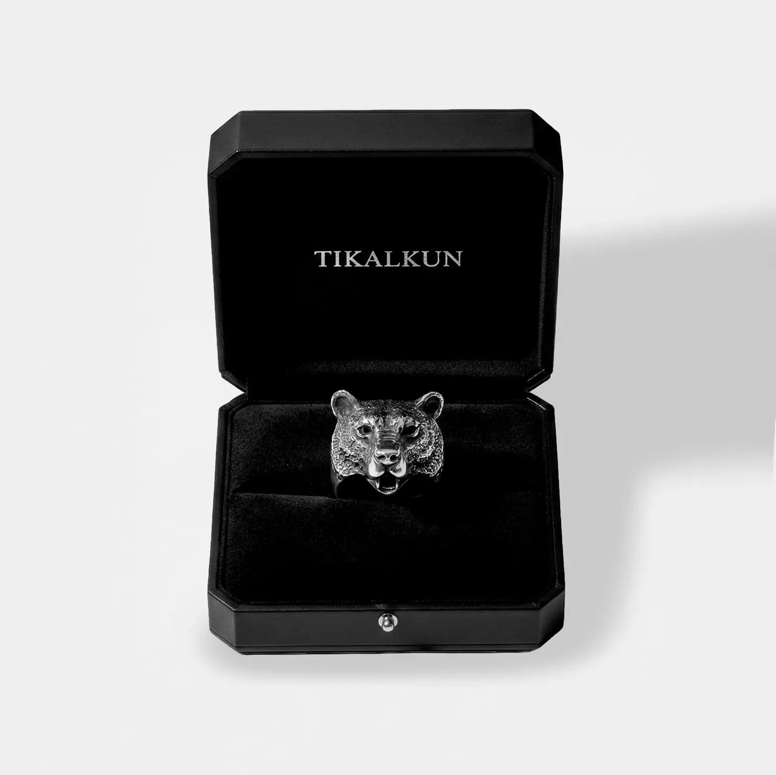 Silver bear-shaped ring in a black Tikalkun box on a light gray background