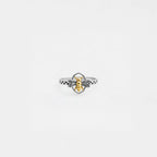 Silver bee ring with gold accents on a light gray background