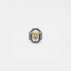 Ring with bee design on a light gray background
