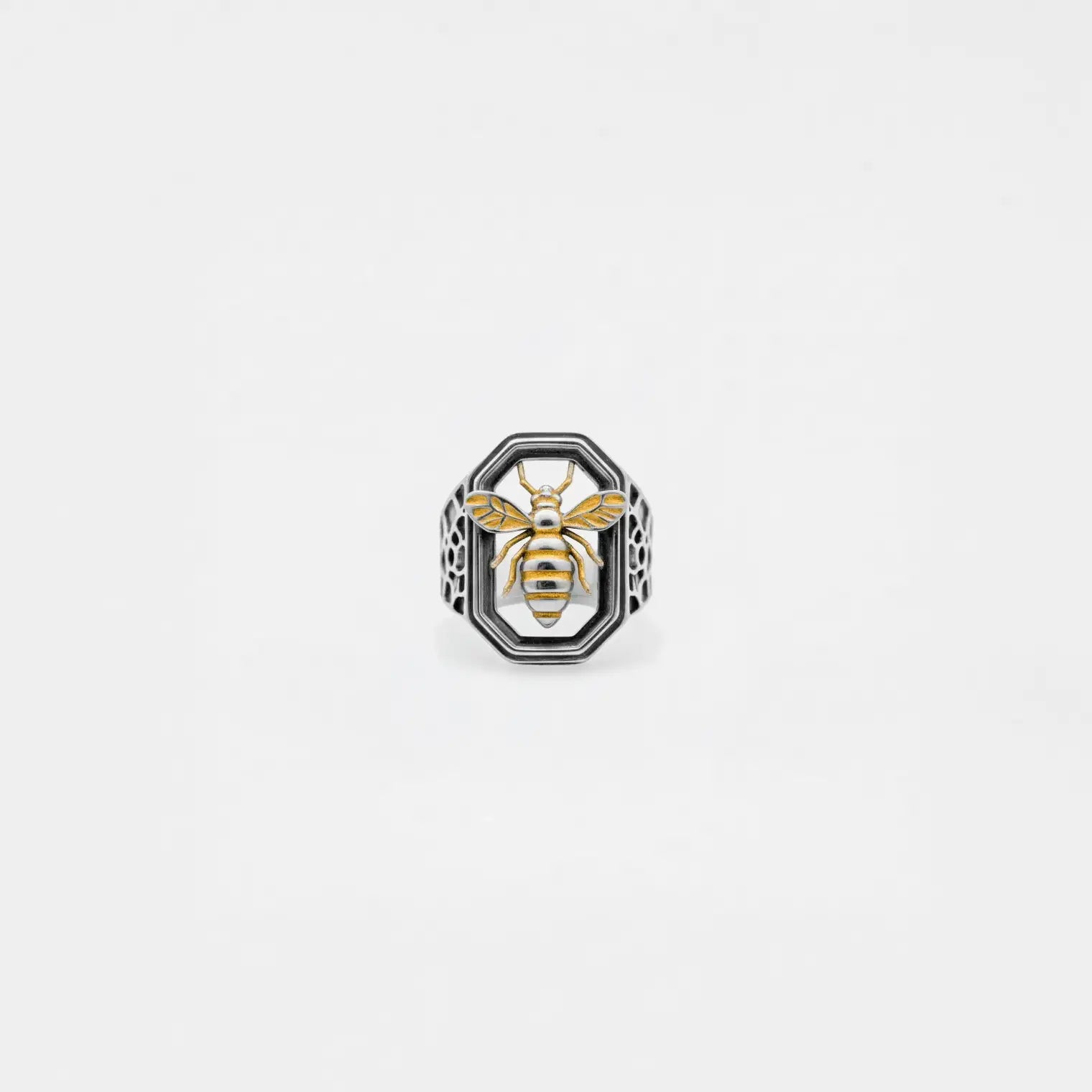 Ring with bee design on a light gray background