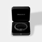 Black braided bracelet in a black Tikalkun box on a light gray background