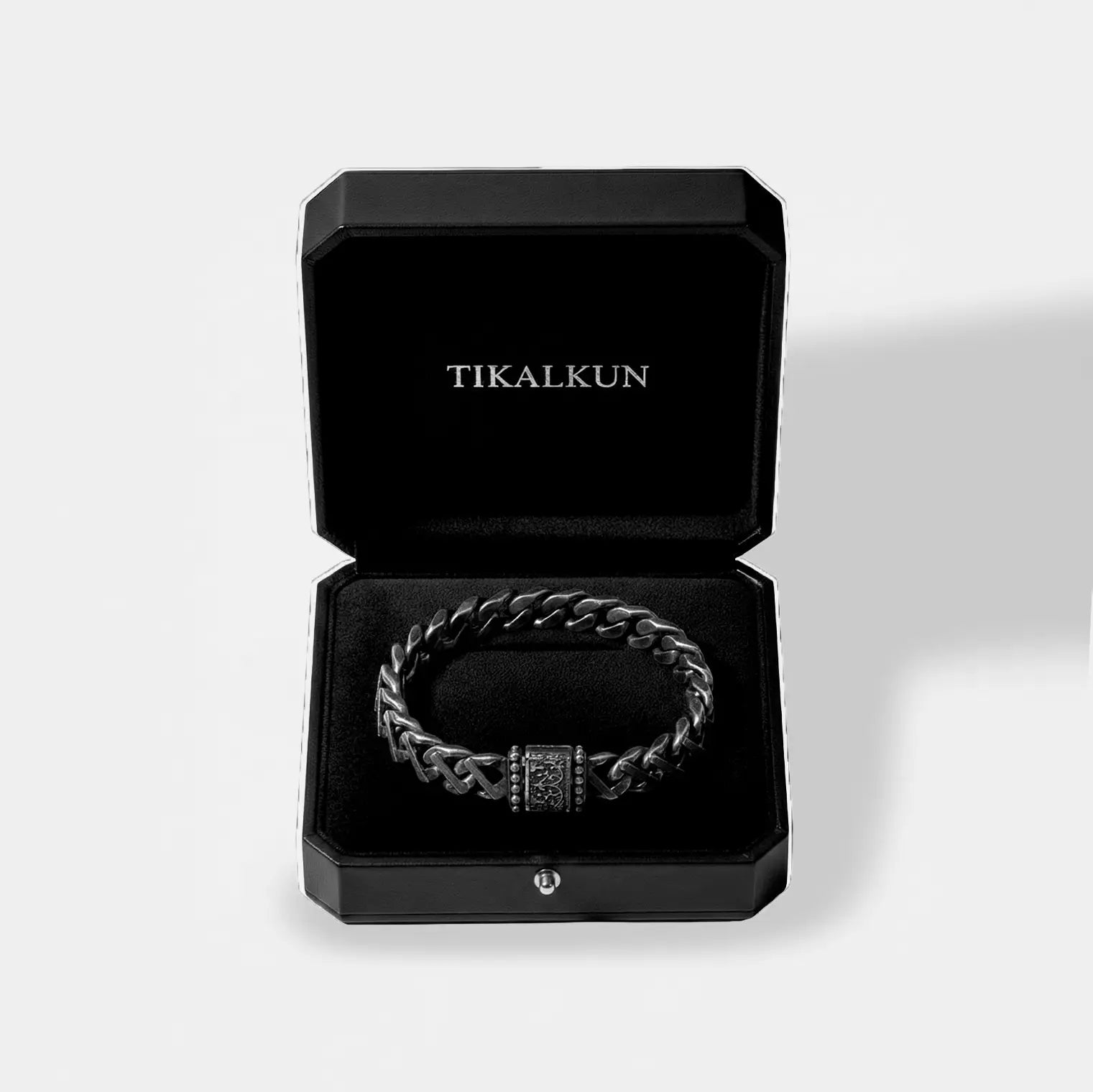 Black braided bracelet in a black Tikalkun box on a light gray background