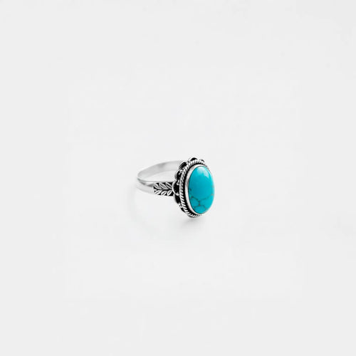 Silver ring with a turquoise stone on a white background