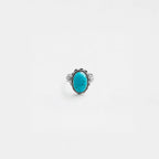 Ring with a turquoise stone on a white background