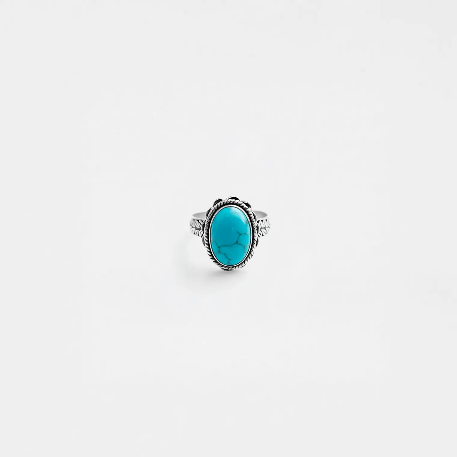 Ring with a turquoise stone on a white background