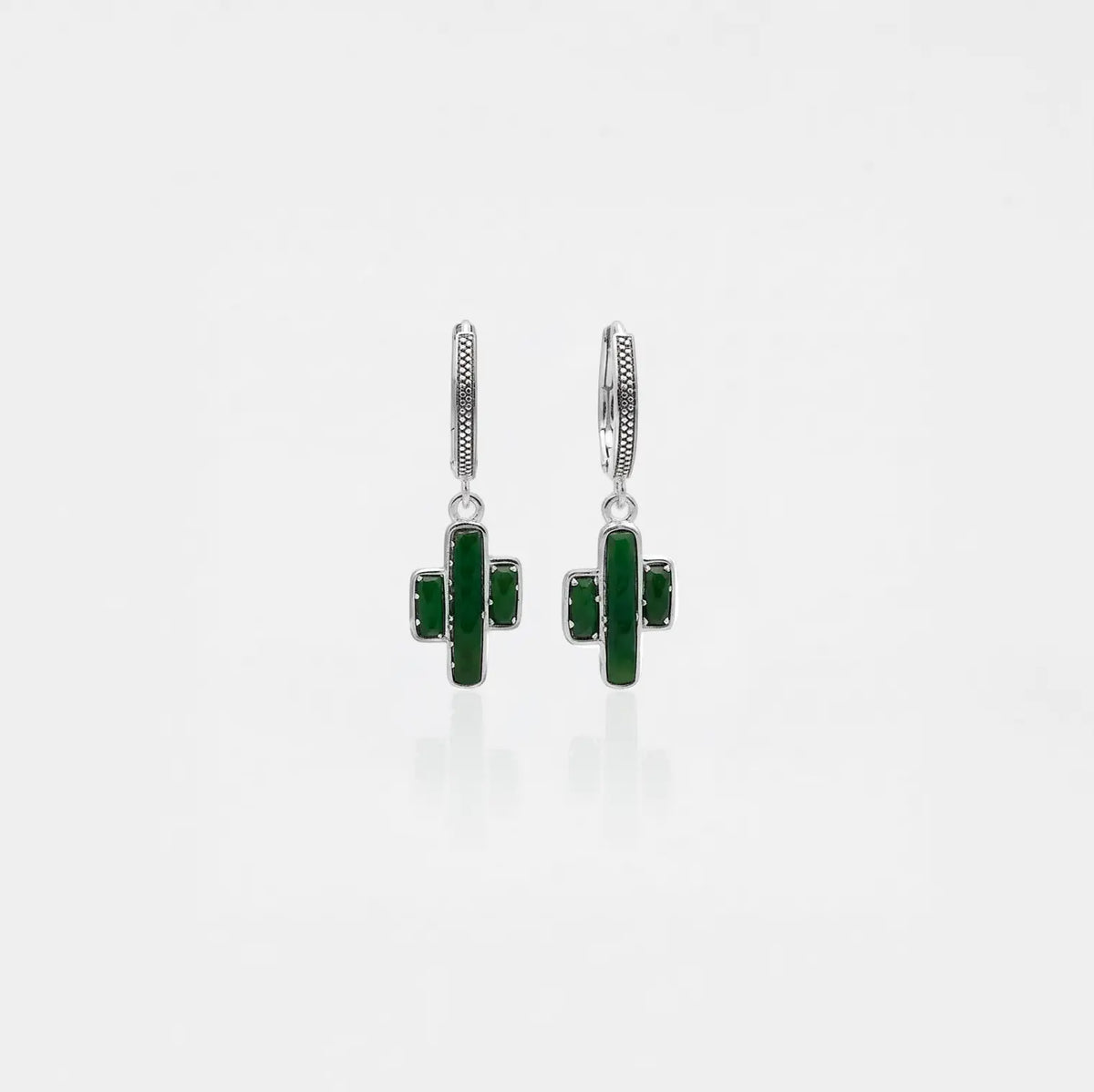 Pair of green cactus-shaped earrings on a white background