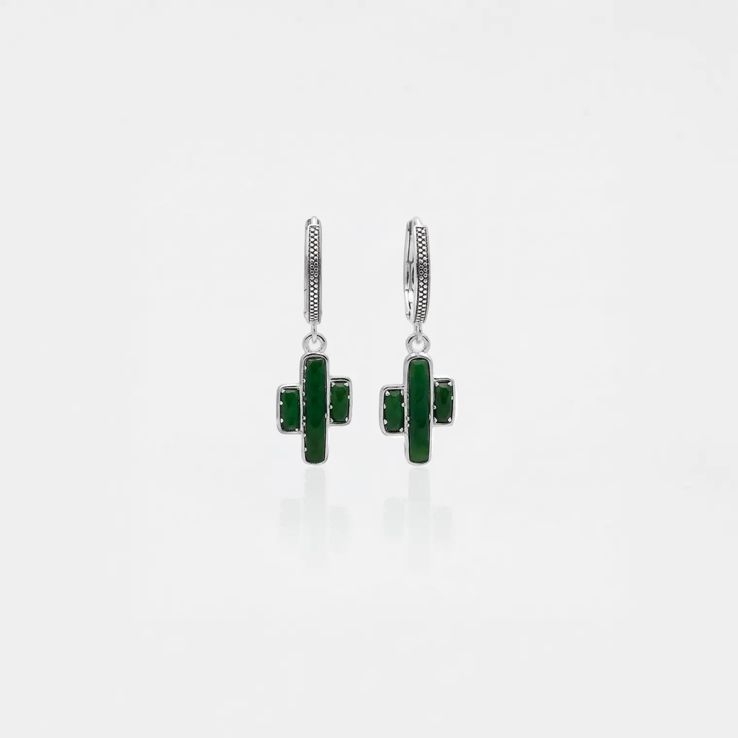 Pair of green cactus-shaped earrings on a white background