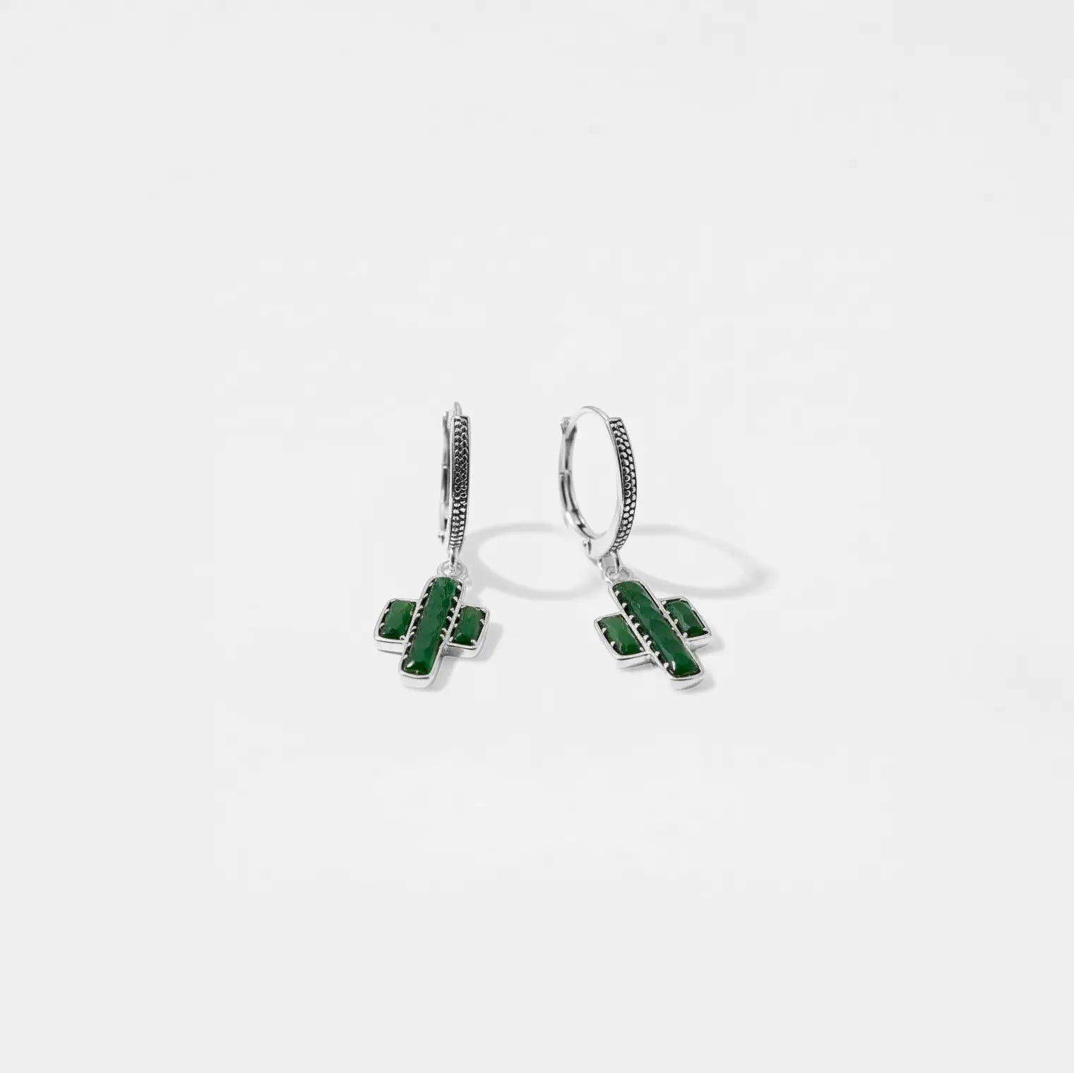 Pair of green cactus earrings on a white background