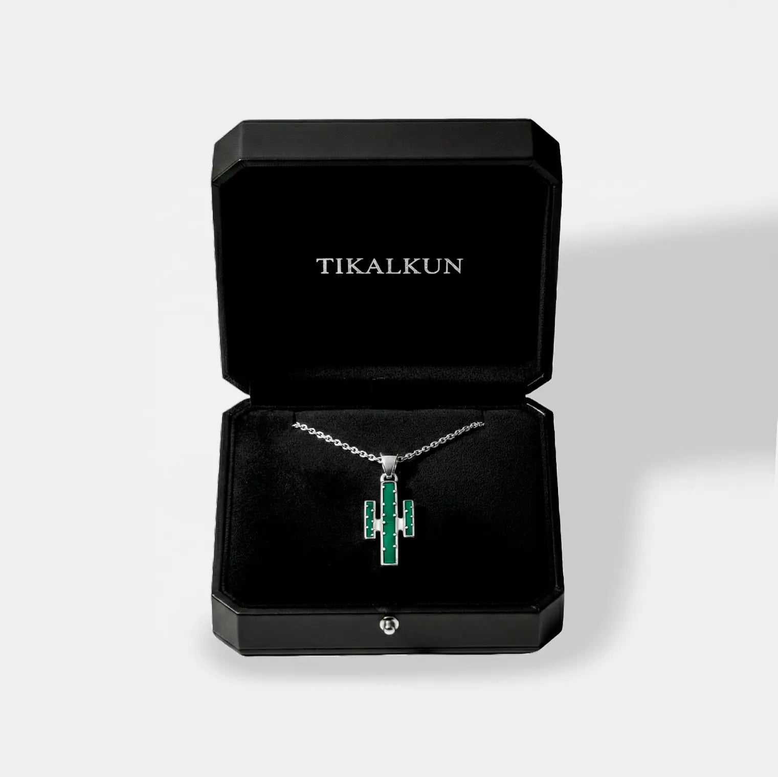 Jewelry box with a necklace featuring a cactus pendant, branded 'TIKALKUN'.