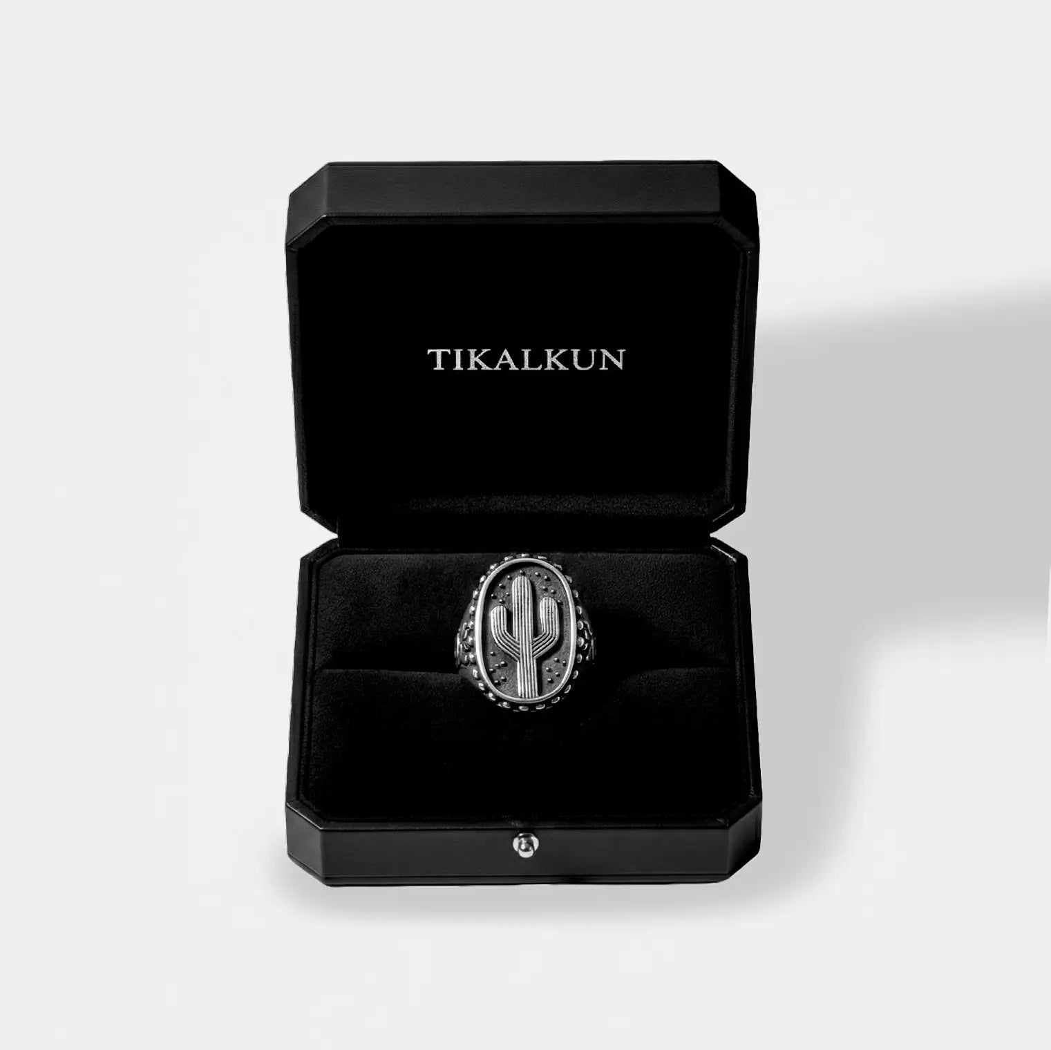 Silver cactus ring in a black Tikalkun box on a light gray background