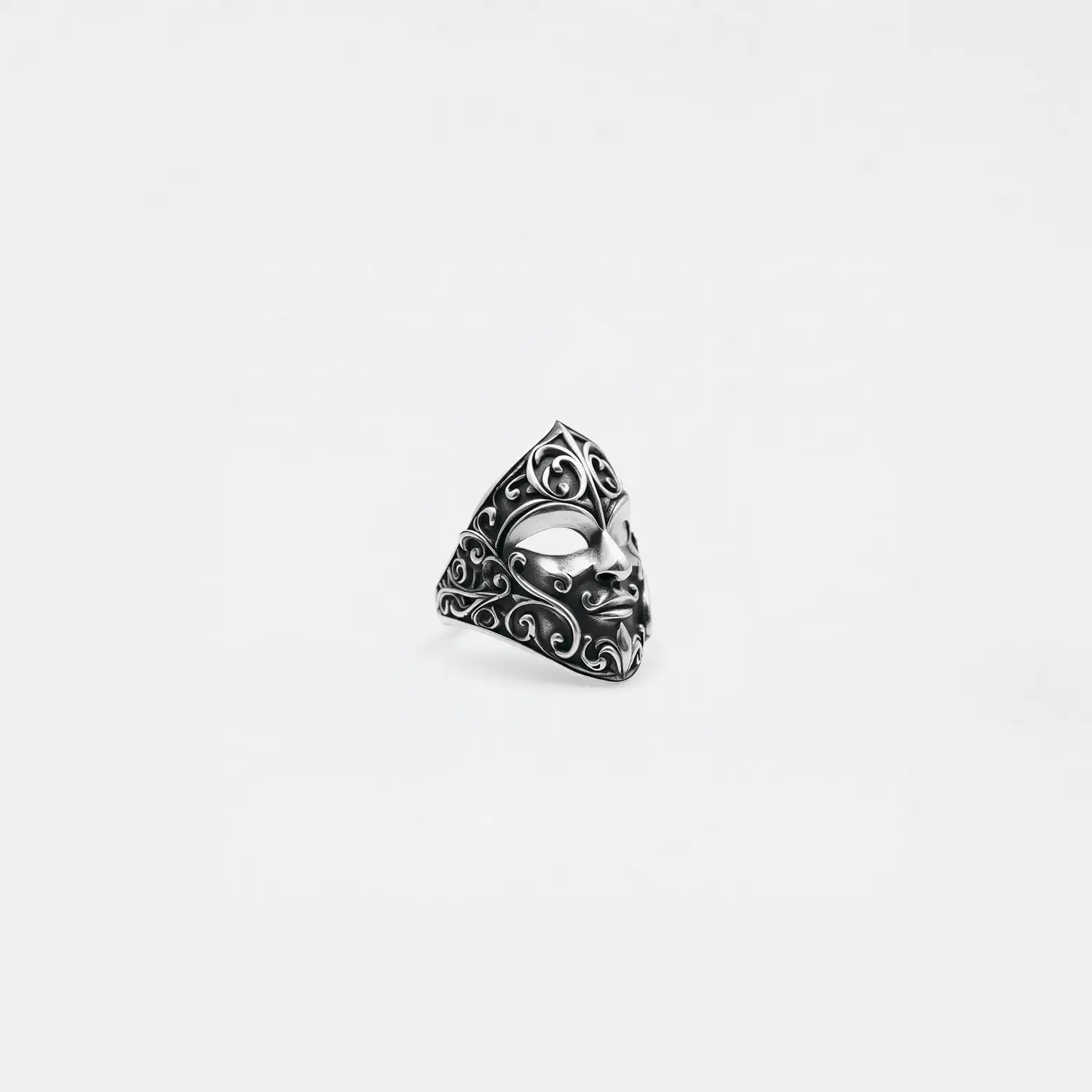 Silver carnival mask ring on a white background