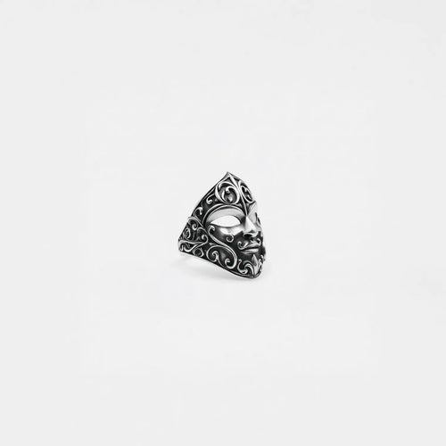 Silver carnival mask ring on a white background