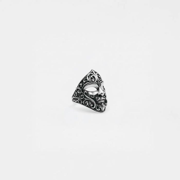 Silver carnival mask ring on a white background