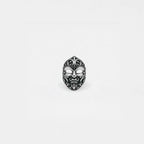 Silver carnival mask ring on a white background