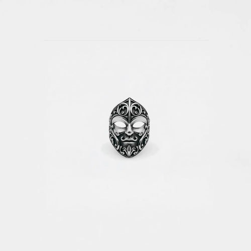 Silver carnival mask ring on a white background