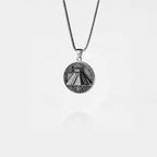 Silver necklace with a pyramid pendant on a white background