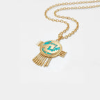 aztec shield gold necklace with turquoise stone on a white background
