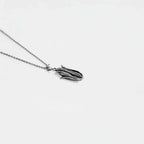 Silver necklace with a unique corn on a light gray background