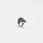Silver ring with a crocodile design on a light gray background