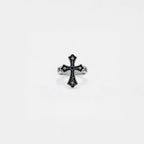 Silver cross ring with gemstone on a white background