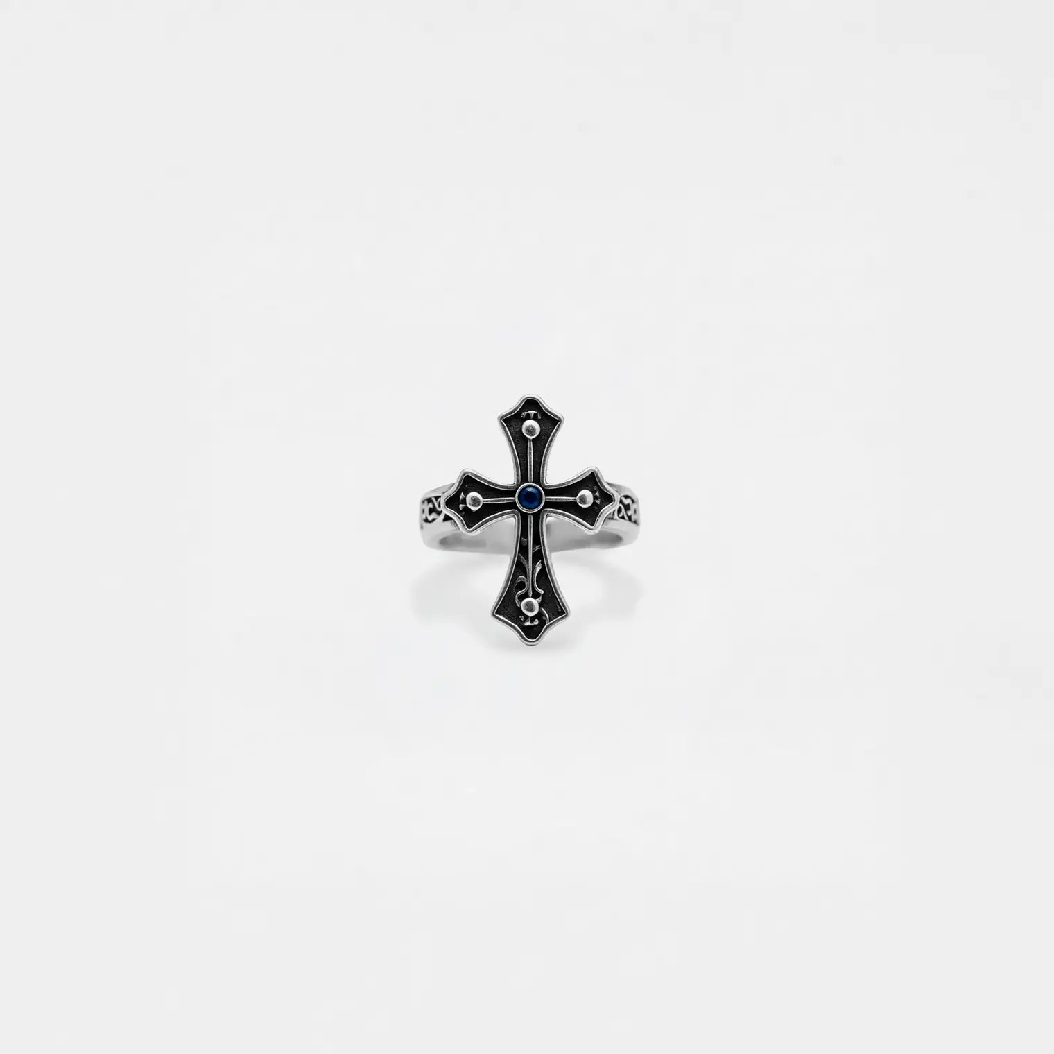 Silver cross ring with gemstone on a white background