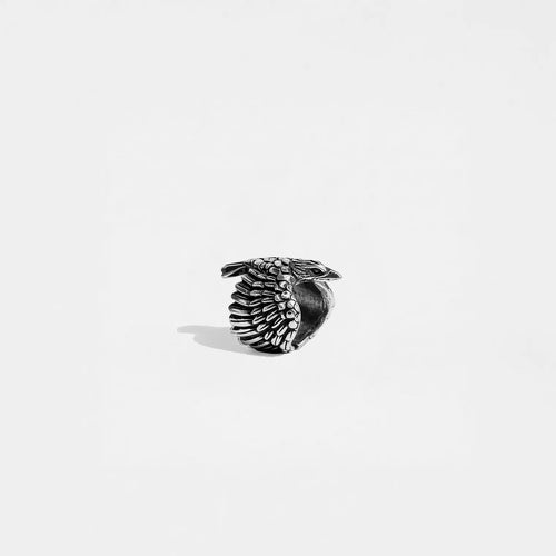 Silver ring with a crow design on a white background