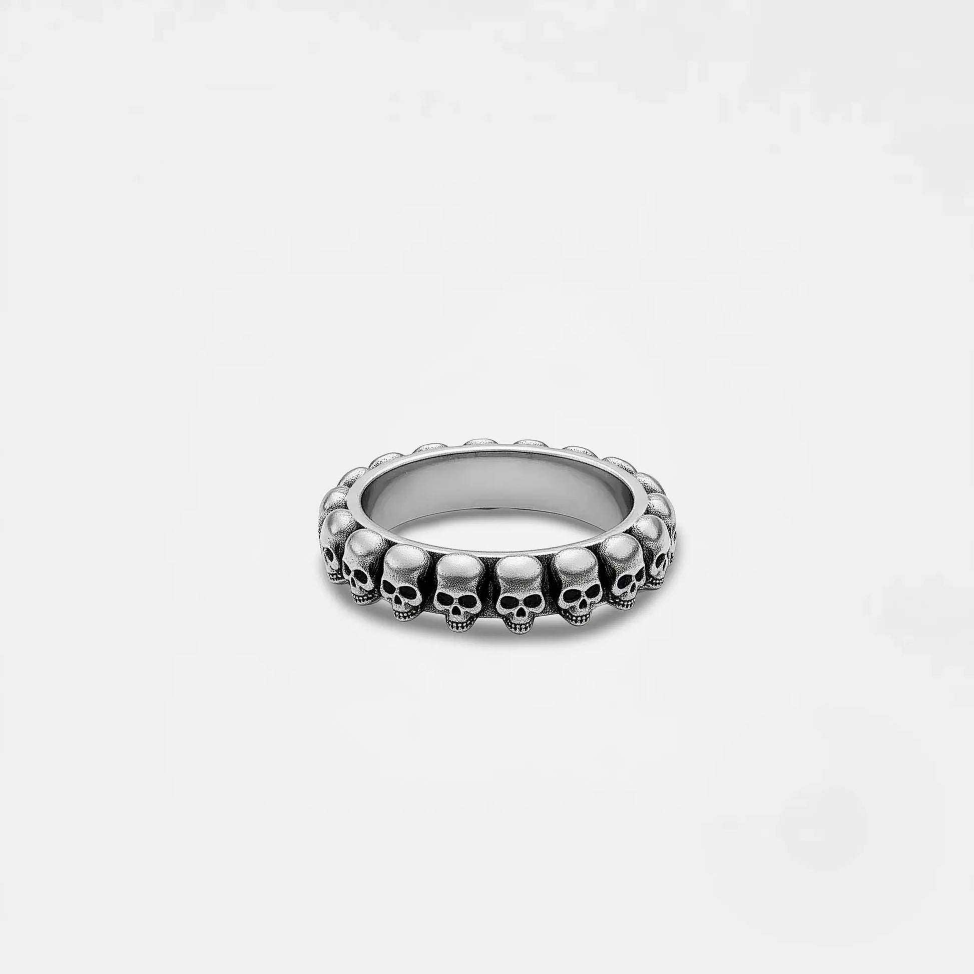 Silver skull ring on a light gray background
