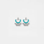 Pair of aztec earrings with turquoise accents on a white background