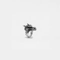 Silver ring with dragon design on a white background