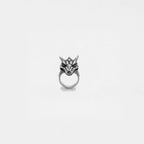 Silver dragon head ring on a light gray background