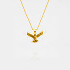 Gold eagle pendant necklace on a white background