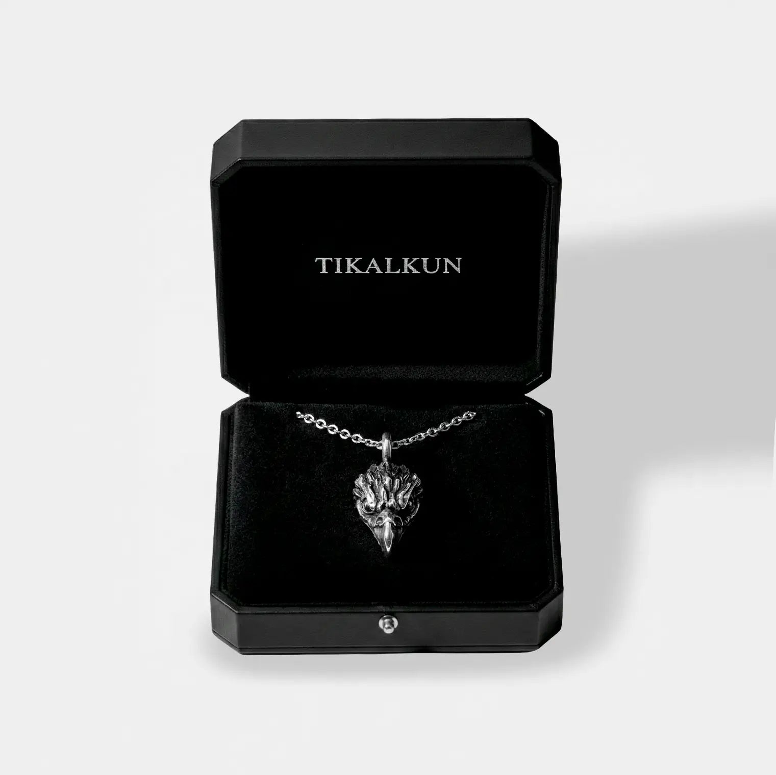 eagle head silver necklace in a black Tikalkun jewelry box on a light gray background