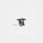 Silver ring with an eagle design on a white background