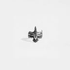 Silver eagle-shaped ring on a light gray background